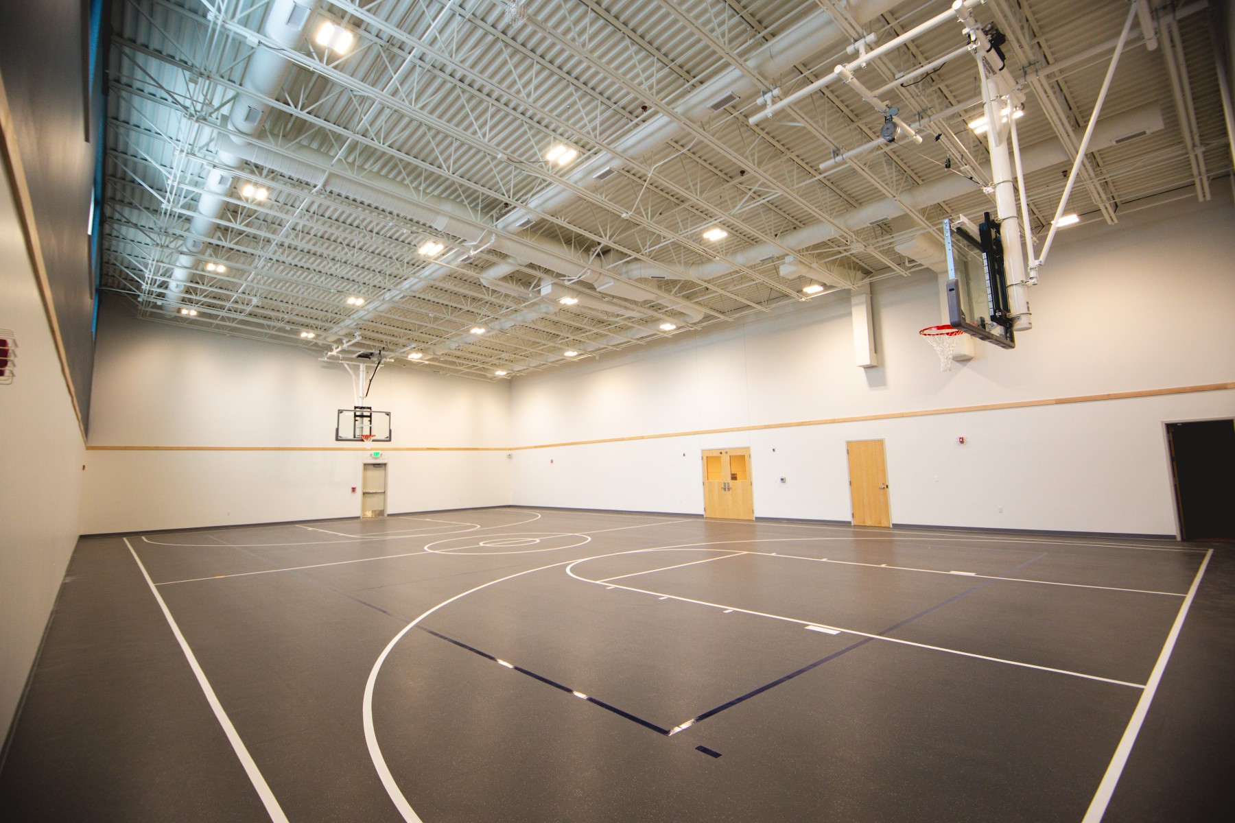 Empty indoor basketball court with high ceiling