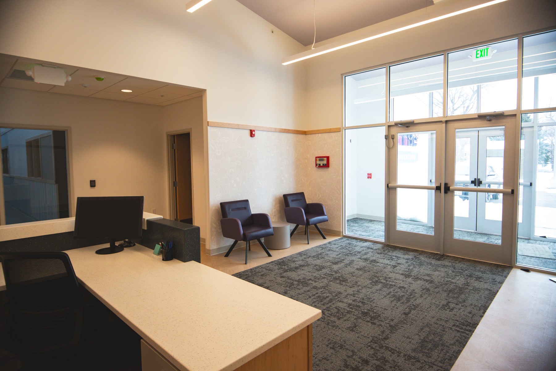 Modern office reception area with desk and chairs